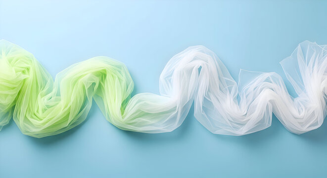Light blue background with a wavy sheer fabric transitioning from green to white across the frame
