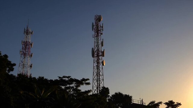Sunrise Over Kab Hill Featuring Telecommunications Tower and Smaller Weather Monitoring Structure Amidst Clear Morning Sky