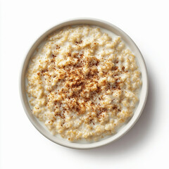 Oatmeal porridge sprinkled with cinnamon on a white background, top view