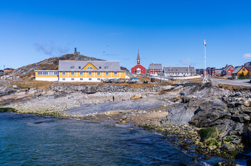 Collection of homes with Hans Egede statue on hilltop by Church of our Saviour in Nuuk in Greenland