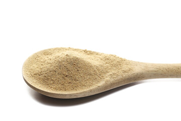 Cardamom ground pile in wooden spoon isolated on white background, side view