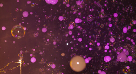Floating violet bubbles with iridescent reflections on a dark background, featuring bokeh effects and a surreal, dreamy atmosphere
