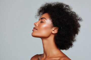 A radiant woman closes her eyes in serene tranquility, bathed in soft light. She embodies inner peace and contentment, the perfect symbol of relaxation and self-care.