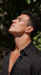 A portrait of a man basks in the warm embrace of sunlight, eyes closed and face lifted, his skin glowing with health and vitality.