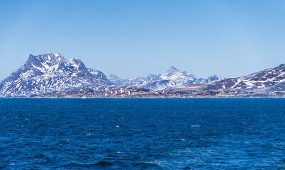 Scenic view of colorful houses nestled along the coast of Nuuk, Greenland, with Sermitsiaq mountain in the background