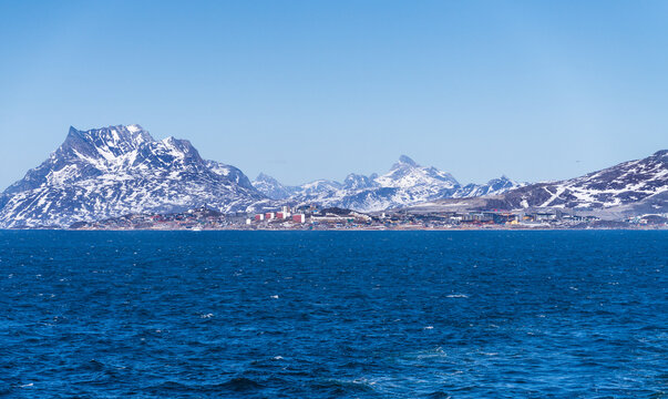 Scenic view of colorful houses nestled along the coast of Nuuk, Greenland, with Sermitsiaq mountain in the background