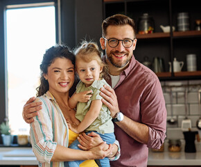 Portrait of mother, father and daughter having fun at home, family life, parenting, love and bonding concepts