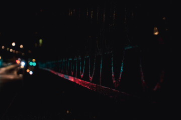 Close up of a metal fence during night