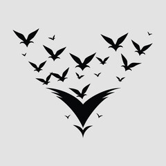 Naklejka premium Pure black design of a group of small birds in flight, forming a V-shape flock, isolated on white background 