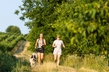 two women friends running in nature