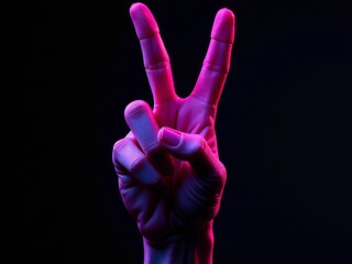 Obraz premium A hand displays the peace sign with colorful pink and blue lighting against a dark backdrop.