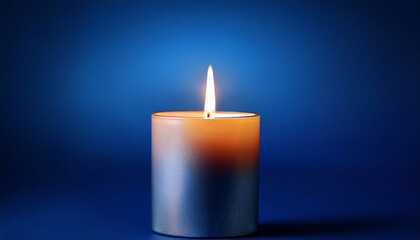 glowing candle with warm flame illuminates dark blue background creating serene and peaceful atmosphere simplicity of design highlights candle gentle light