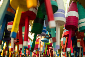 A colorful collection of buoys hanging from the ceiling