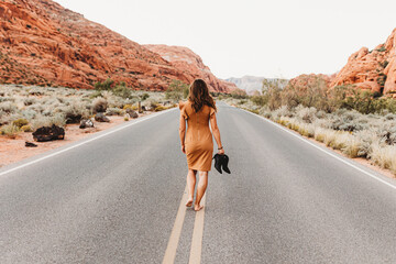 young woman walking on the desert road
