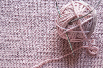 A Soft Pink Yarn Ball on a Beautifully Knitted Texture Background that Delights the Senses