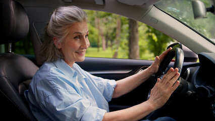 Joyful active smiling Caucasian aged lady woman elderly female senior dealership testing client grandmother auto buyer car driver inside automobile turn on music dancing sing song audio system dance