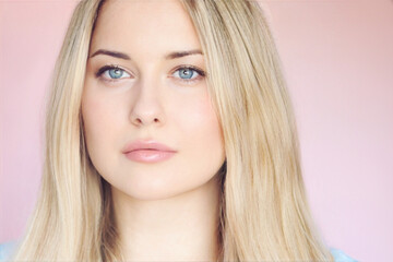 Naklejka premium Smooth hairstyle, healthy hair, glowing skin and fresh feminine beauty. Blonde woman with long blonde hair and natural skincare look in soft lighting