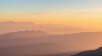 Mountain Sunrise: Capturing the essence of tranquility, this photo reveals layered mountain peaks bathed in the soft, golden hues of a tranquil dawn.