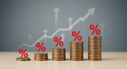Ascending stacks of coins illustrate increasing interest rates and financial growth.