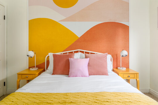 Desert modern boho chic bedroom interior. Bed, side tables, and lamps