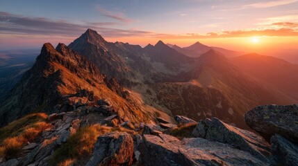 Majestic mountain range at sunset.  Rocky peaks bathed in golden light