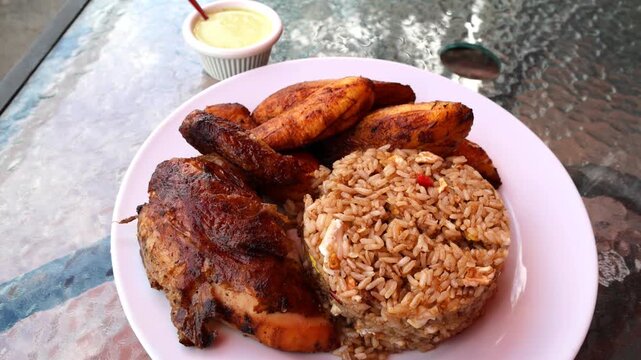 peruvian fried chicken dish with pork and egg fried rice fried sweet plantains and spicy green sauce (peru cuisine restaurant special meal ossining new york) white plate rotisserie pollo asian fusion