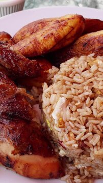 peruvian fried chicken dish with pork and egg fried rice fried sweet plantains and spicy green sauce (peru cuisine restaurant special meal ossining new york) white plate rotisserie pollo asian fusion