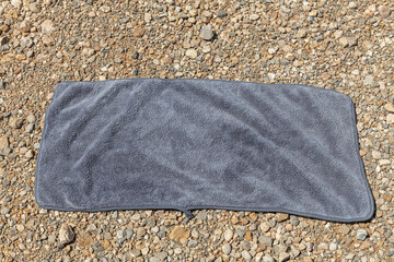 A gray towel on the orange and yellow stones background