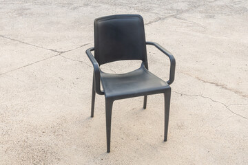 Plastic black chair on the gray background