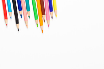 Collection of colorful sharpened pencils on a white background with copy space.