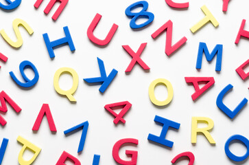 Colorful foam letters and numbers on white background.