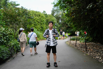 man exploring nature trail in vibrant green forest surrounded by vegetation