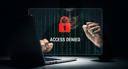 A hooded figure is denied access to a computer system with a red lock icon and access denied displayed on the screen