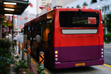 city bus stopped at urban station with vibrant background
