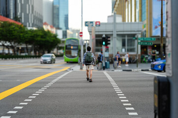 a man walking across a street in singapore
