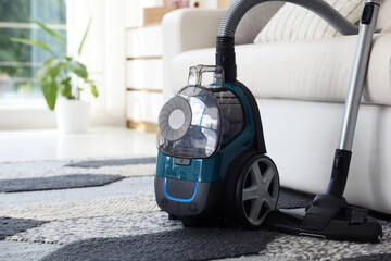 One vacuum cleaner on floor indoors. Household appliance