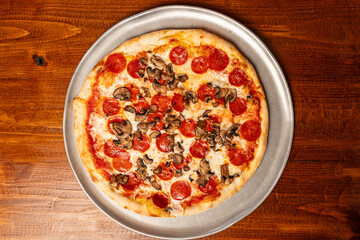 Pizza with pepperoni and mushrooms