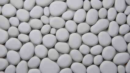 Smooth, white stones densely packed create a calming, textured, organic background, perfect for