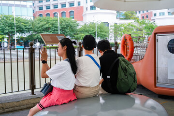 group of people relaxing by the waterfront in an urban setting