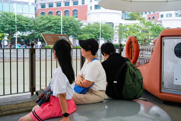 group of people relaxing by the waterfront in an urban setting