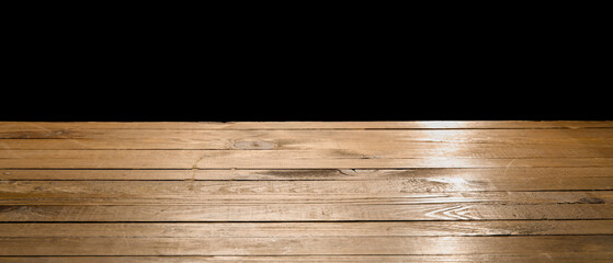 Wooden table top on black background