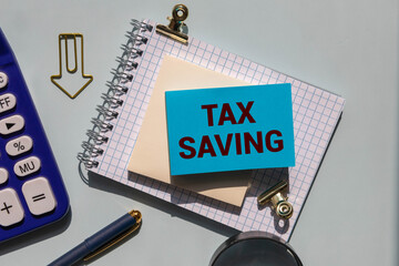 Tax Savings text written on notepad with calculator