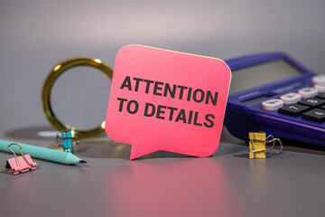 ATTENTION TO DETAILS - words written on wooden blocks near office supplies.