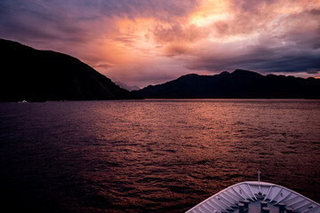 Beautiful sunset on the sea from a cruise ship dark skies water calm scenic milford sound new...