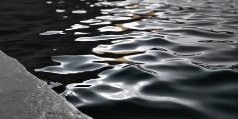 Tranquil Winter Scene, Glistening Silver and Gold Reflections on Dark Water Beside an Icy Edge