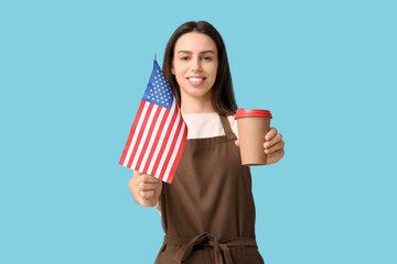 Young female barista with USA flag and cup of coffee on blue background