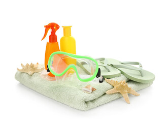Towel, bottles of sunscreen cream, swimming mask, flip-flops and starfishes isolated on white...