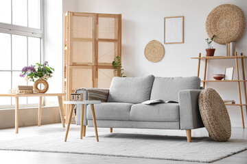 Grey sofa and coffee table in interior of living room