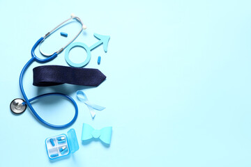 Male sign with ribbon, stethoscope, pills and tie on blue background. Prostate cancer awareness...