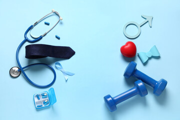 Male sign with ribbon, stethoscope, pills and male accessories on blue background. Prostate cancer...